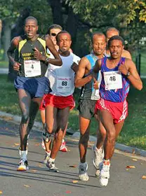 A group of men running on the road