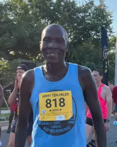 A man is running in the marathon wearing blue