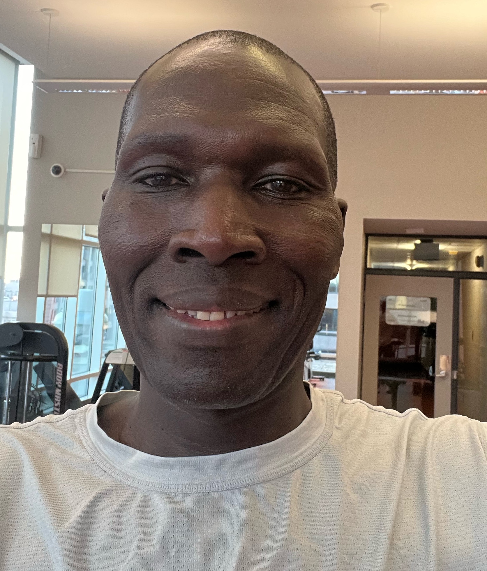 A man in white shirt smiling for the camera.