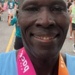 A man with two medals around his neck.