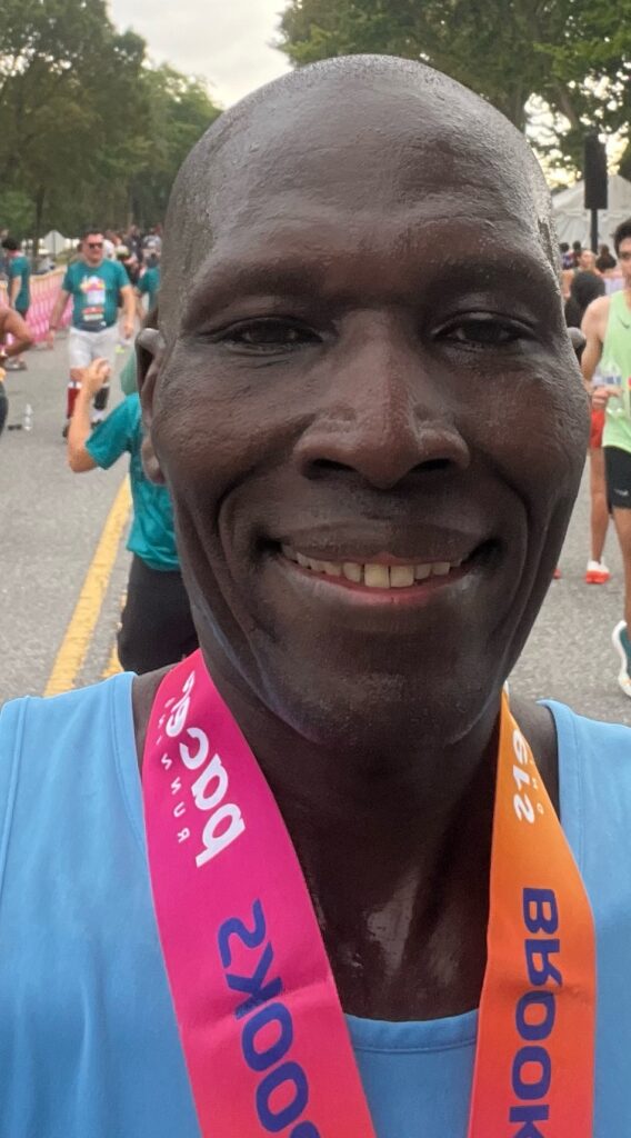 A man with two medals around his neck.