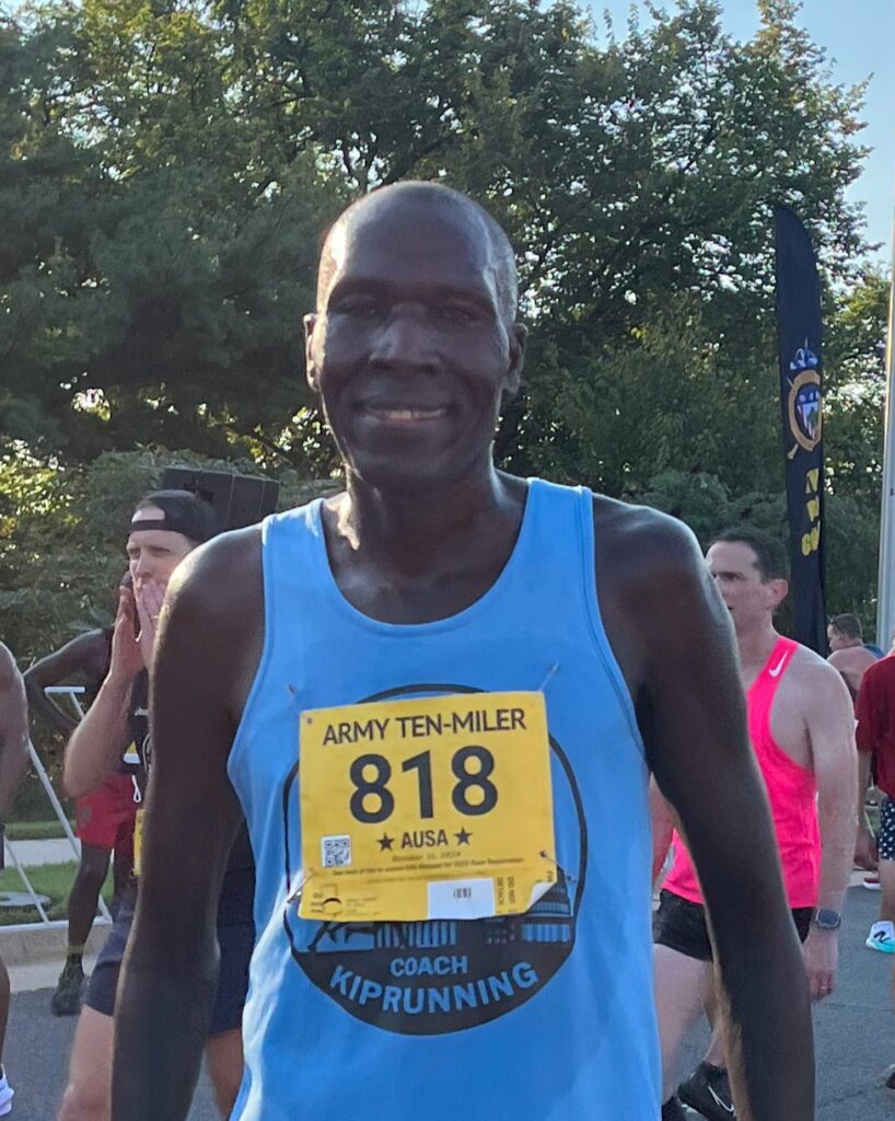 A man is running in the marathon wearing blue