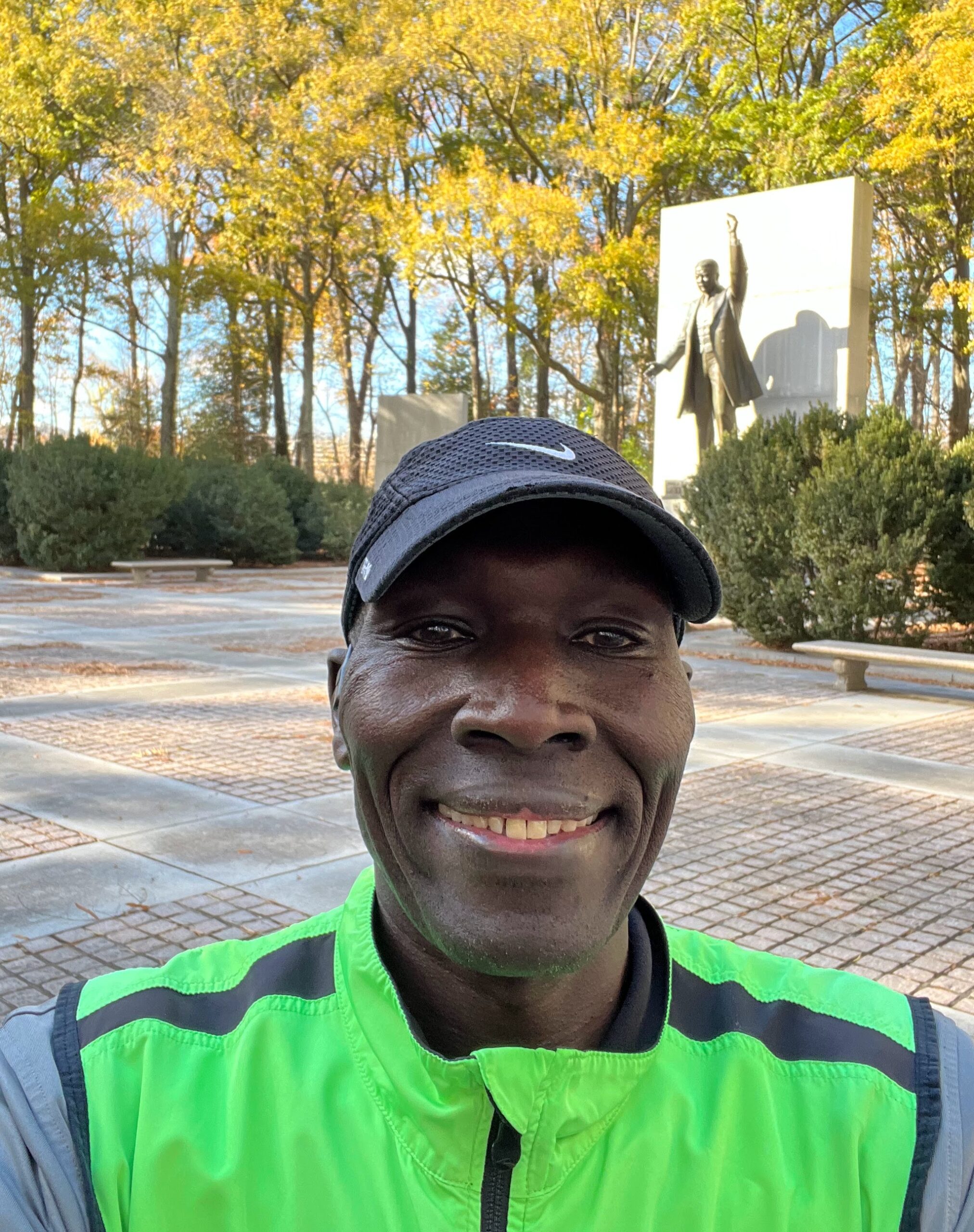 A man in a green shirt and black hat